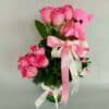 Pink rose in vase with teddy